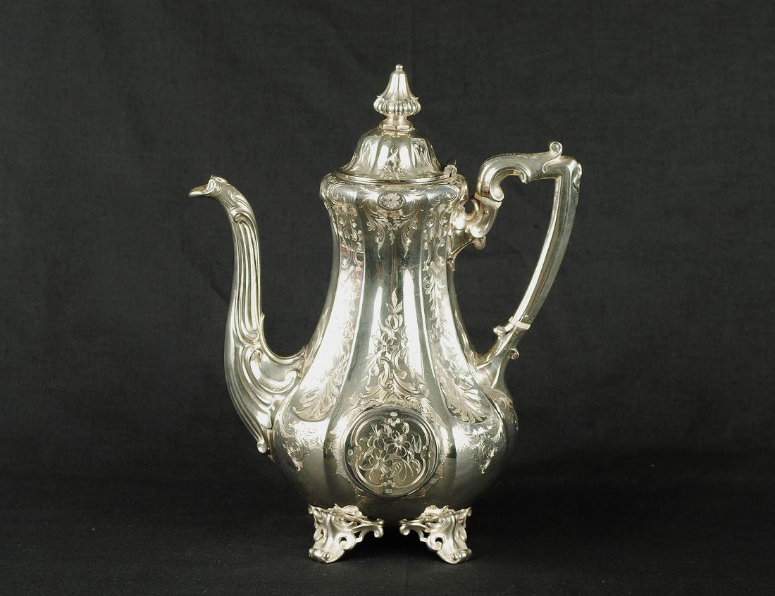 VICTORIAN STERLING SILVER COFFEE POT: English. London. 1851. Maker: Rawlins & Sumner. Engraved with foliate design. Height 10 3/4". (28 oz) (600/800)