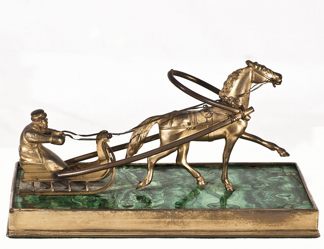 RUSSIAN GILT METAL HORSE AND SLED: With driver holding the reins, mounted on a malachite and gilt metal base. Length 9". (400/600)