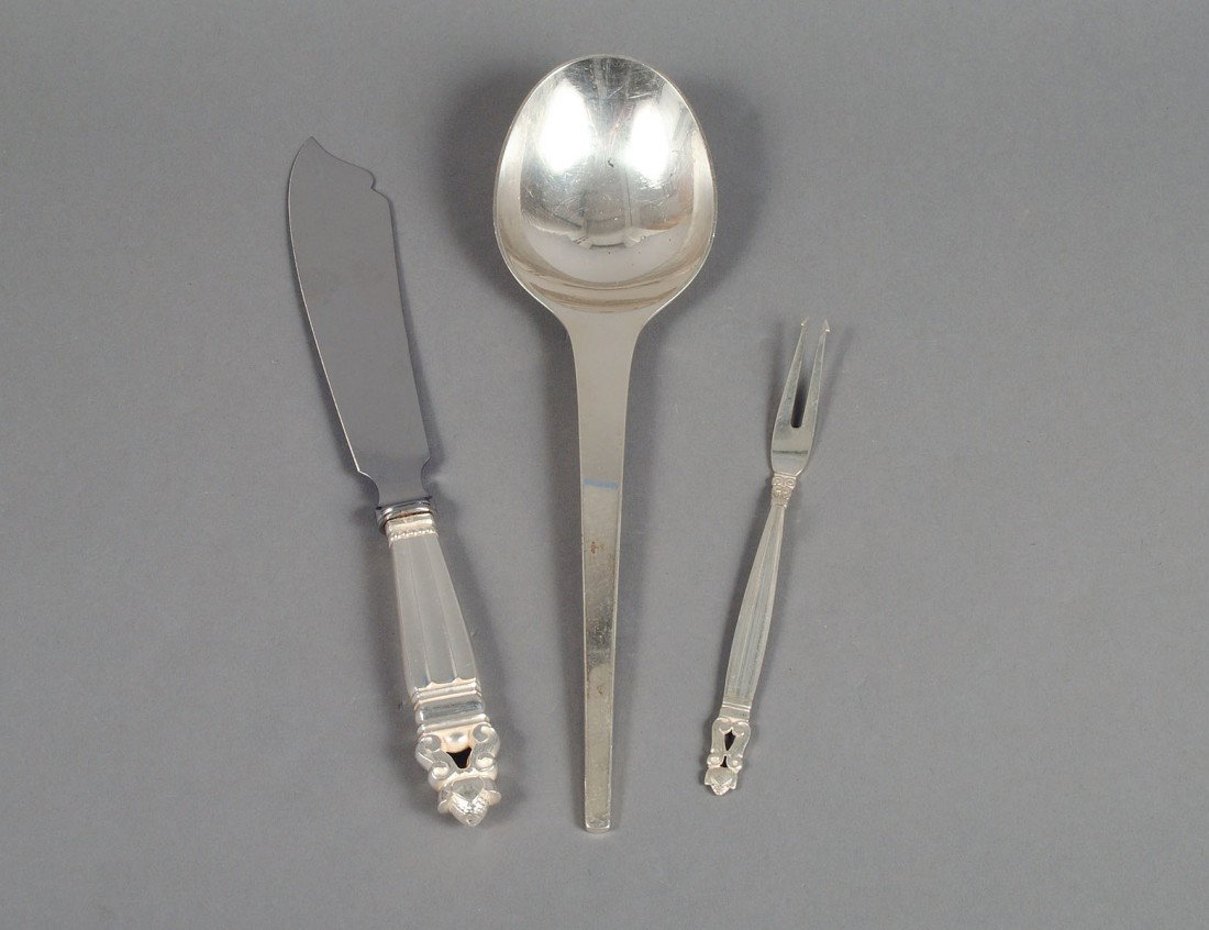 GROUP OF THREE GEORG JENSEN STERLING SILVER SERVING : Danish. Post 1945. Comprising: Acorn fish slice and seafood fork, and a serving spoon in the "Arne Jacobsen" pattern. (9 oz) (300/400)