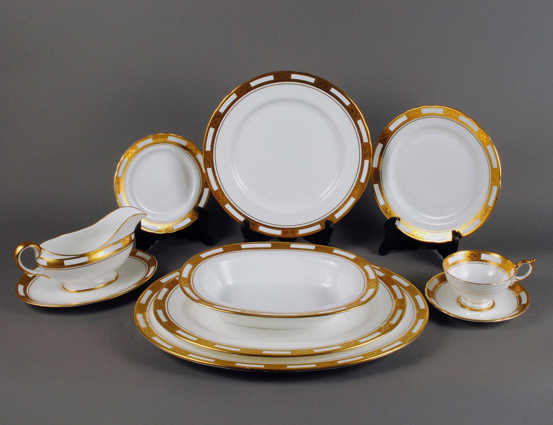 SIXTY-FIVE PIECE AYNSLEY PORCELAIN DINNER SERVICE: English. In the "Empress" pattern. Comprising: eleven dinner plates, twelve salad plates, twelve bread and butter plates, twelve cups and saucers, two platters, two open serving bowls, sauce boat and 