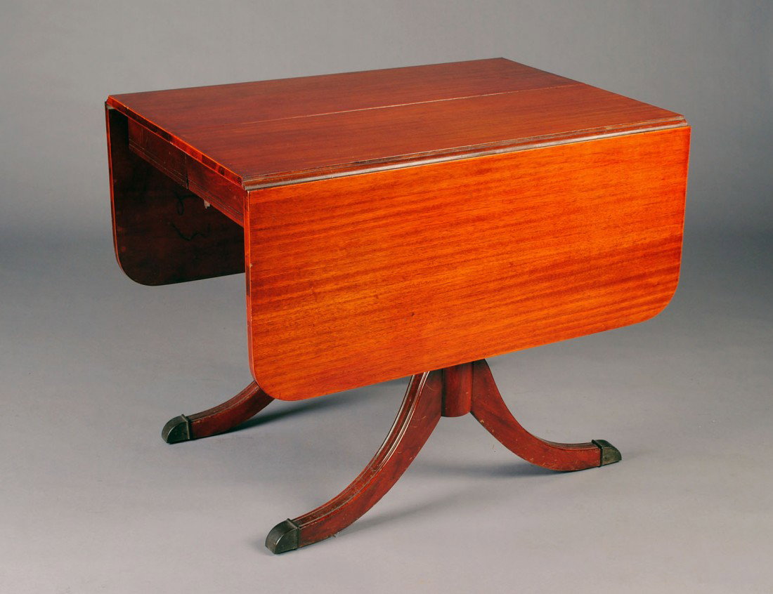 GEORGE III STYLE MAHOGANY DROP LEAF TABLE: American. The rectangular top hinged with D-shaped flaps raised on baluster standards ending in downswept legs. Height 28 1/2". Width 26 1/2". Depth 35 3/4". Each flap measuring 15 1/4". (Cond: no ext