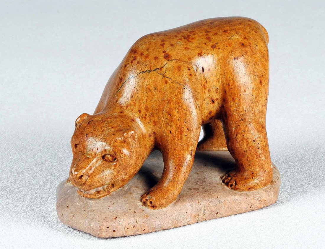 CARVED STONE FIGURE OF A GROWLING BEAR: Inuit. By Dell Warner. Signed. Height 4". Length 5 1/2". (125/175)