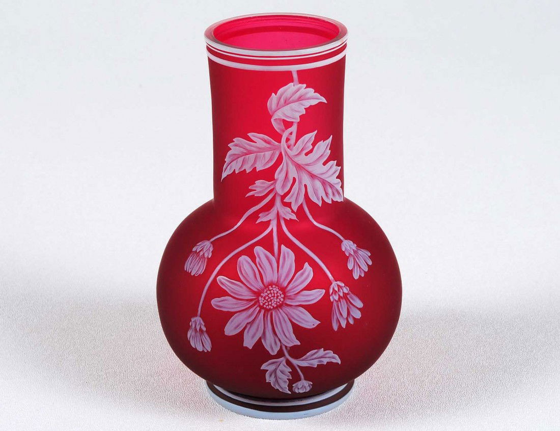 THOMAS WEBB CAMEO GLASS VASE: English. Impressed Thomas Webb and Sons, Cameo. The ruby glass overlaid and cut with white flowers, leaves and a butterfly. Height 6". (800/1200)