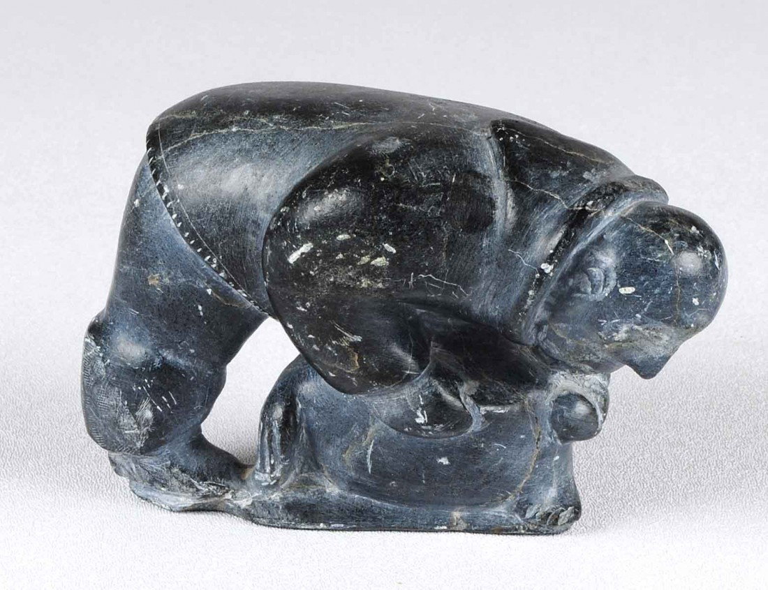 CARVED ARGILLITE GROUP: Inuit. By Joane Sialuq. Signed. Of an Inuk man with a seal. Length 5 3/4". Height 3 1/2". (150/200)