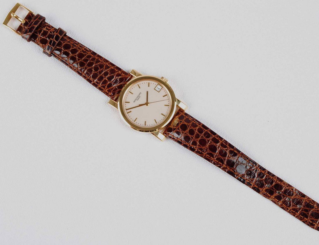 PATEK PHILIPPE EIGHTEEN KARAT YELLOW GOLD WRISTWAT: With original lizard skin band. (12000/15000)