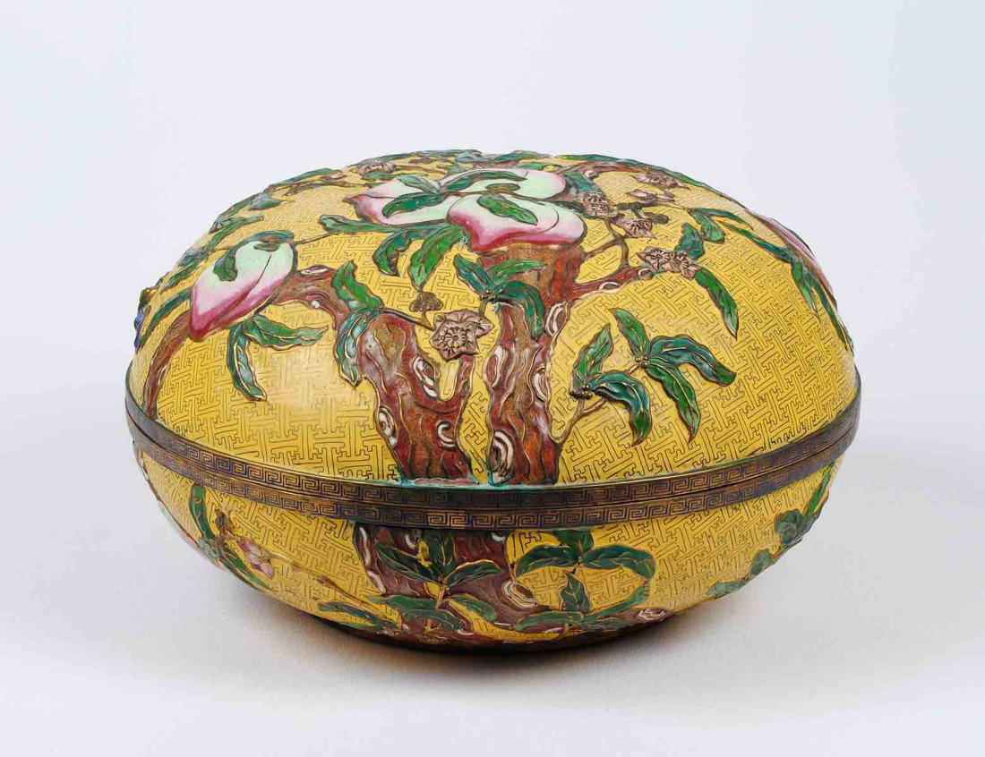 IMPRESSIVE CLOISONNE ENAMEL "PEACH" BOX AND COVER: Chinese. The globular container decorated with peaches, leaves and bats reserved on a yellow ground. Diameter 15 ¾". (800/1200)