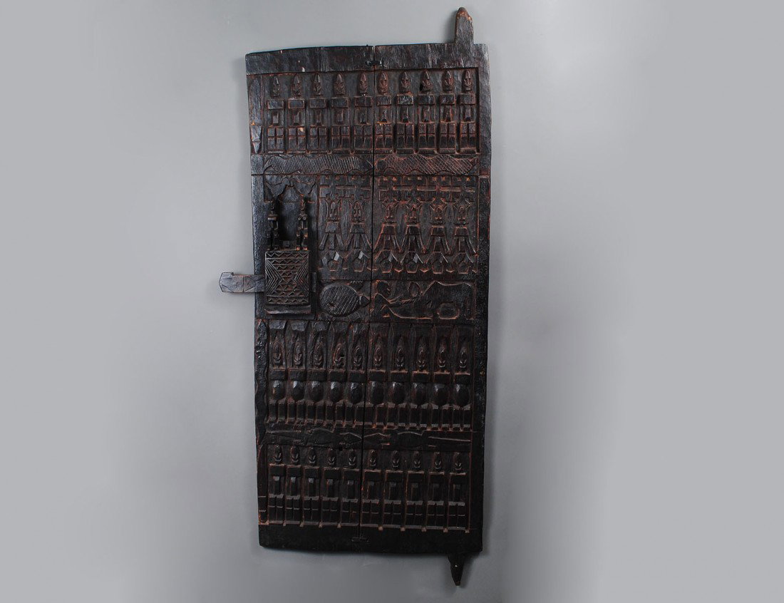 WEST AFRICAN DOGON TRIBAL GRANARY DOOR: Mali. Carved in relief with figures, animals and geometric motifs. Height 54 1/2". (Cond: good) (600/800)