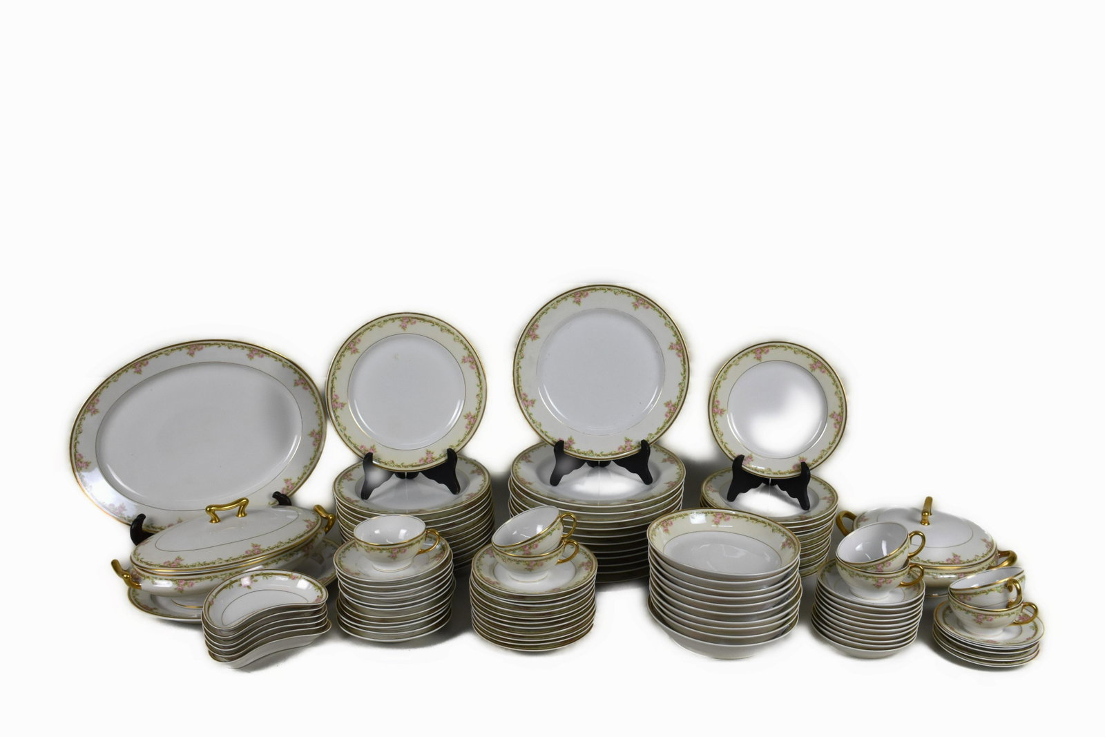 LIMOGES PORCELAIN ONE HUNDRED-AND-SEVEN PIECE DINNER SERVICE The underside with factory marks.: LIMOGES PORCELAIN ONE HUNDRED-AND-SEVEN PIECE DINNER SERVICE The underside with factory marks. Decorated with scattered rose clusters, gilt border. Comprising, 12 diner plates, 12 luncheon plates, 12 