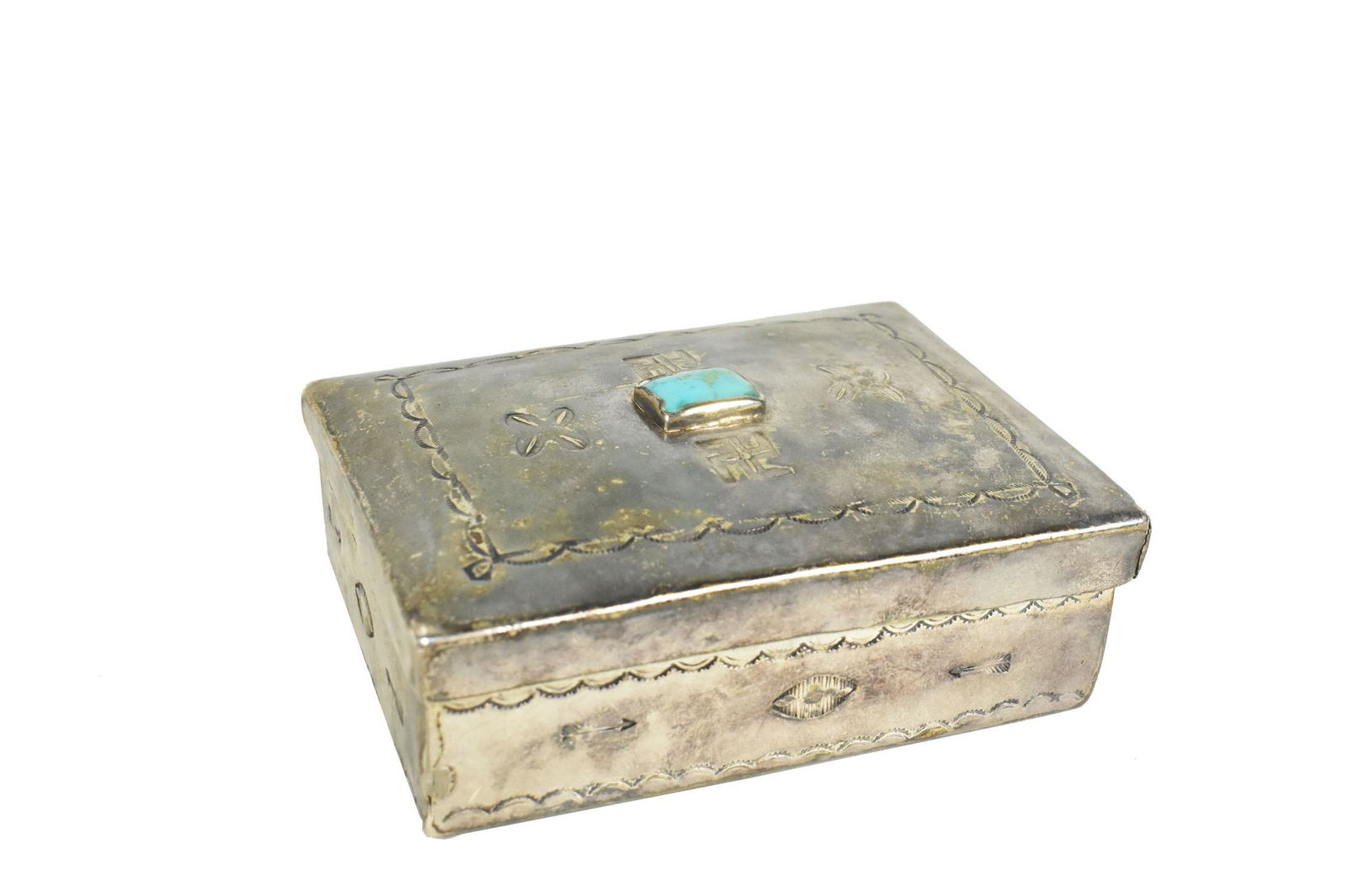 NAVAJO TURQUOISE MOUNTED LIDDED SILVER BOX Circa 1940. Unmarked. Rectangular, with incised motifs. 1 (1 of 5)