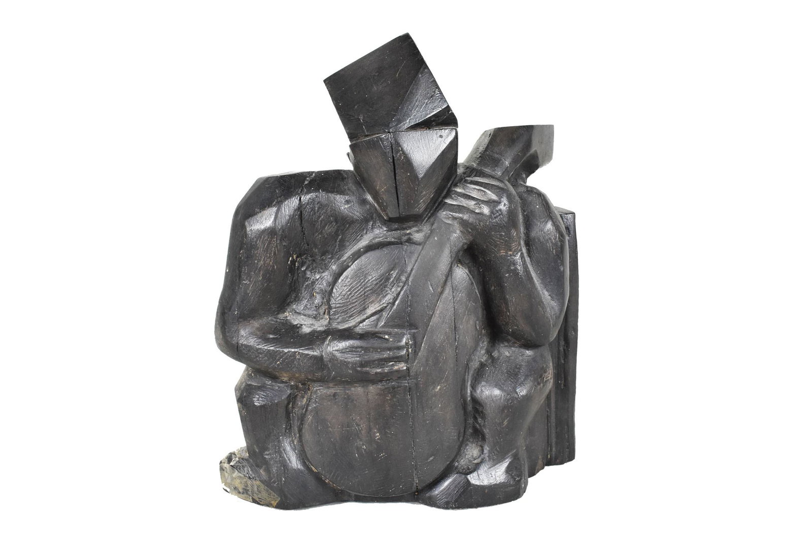 AMERICAN SCHOOL, MODERNIST CARVED EBONY/ROSEWOOD GUITARIST Circa 1945. The seated figure strumming: AMERICAN SCHOOL, MODERNIST CARVED EBONY/ROSEWOOD GUITARIST Circa 1945. The seated figure strumming his guitar. Height 11.25 in., Width 8.5 in., Depth 5.5 in. Note: broken piece on toe, will need repai