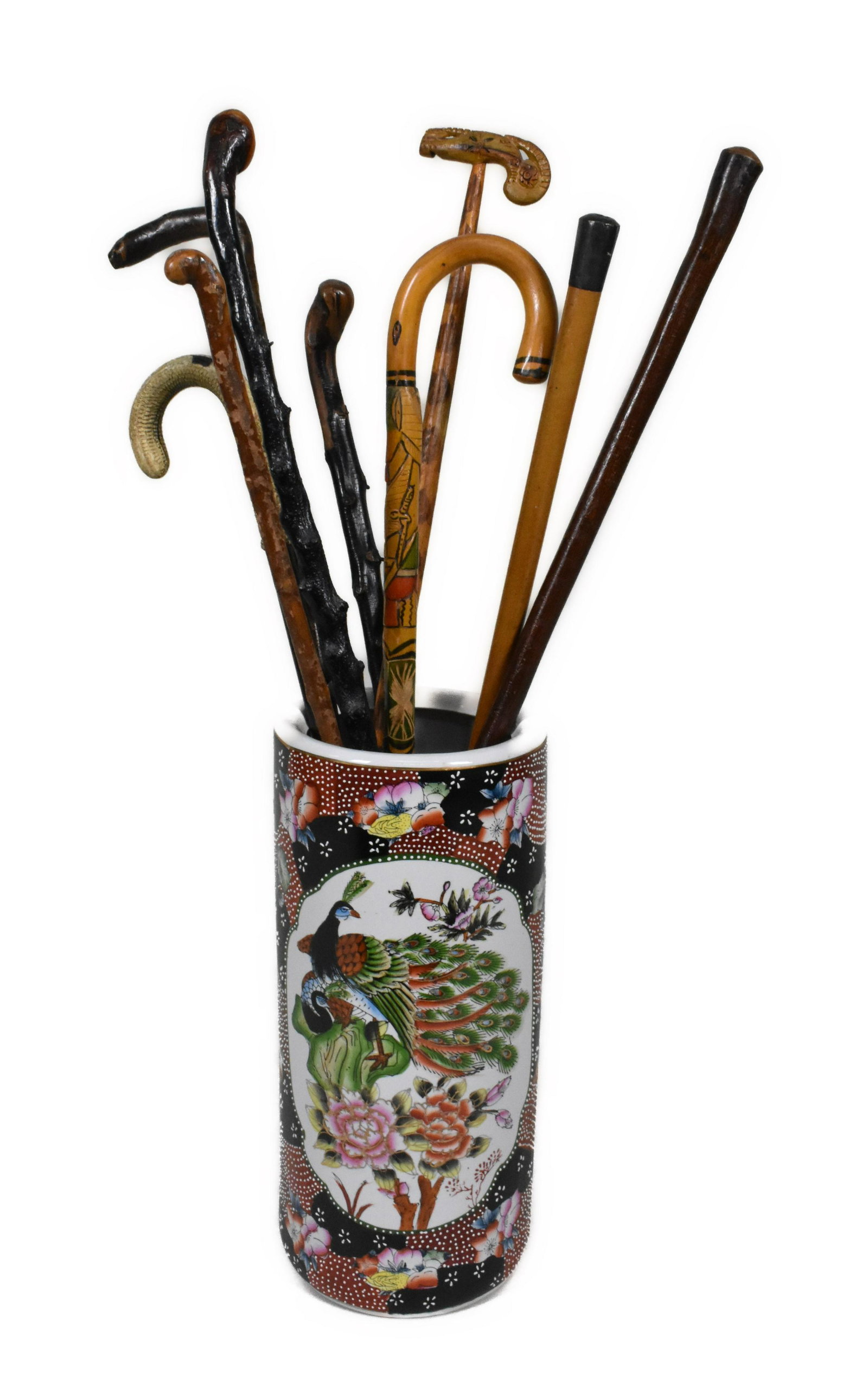 JAPANESE MORIAGE PORCELAIN CYLINDRICALMBRELLA STAND AND NINE ASSORTED CANES, Sticks of varying: JAPANESE MORIAGE PORCELAIN CYLINDRICALMBRELLA STAND AND NINE ASSORTED CANES, Sticks of varying heights. 19" high.