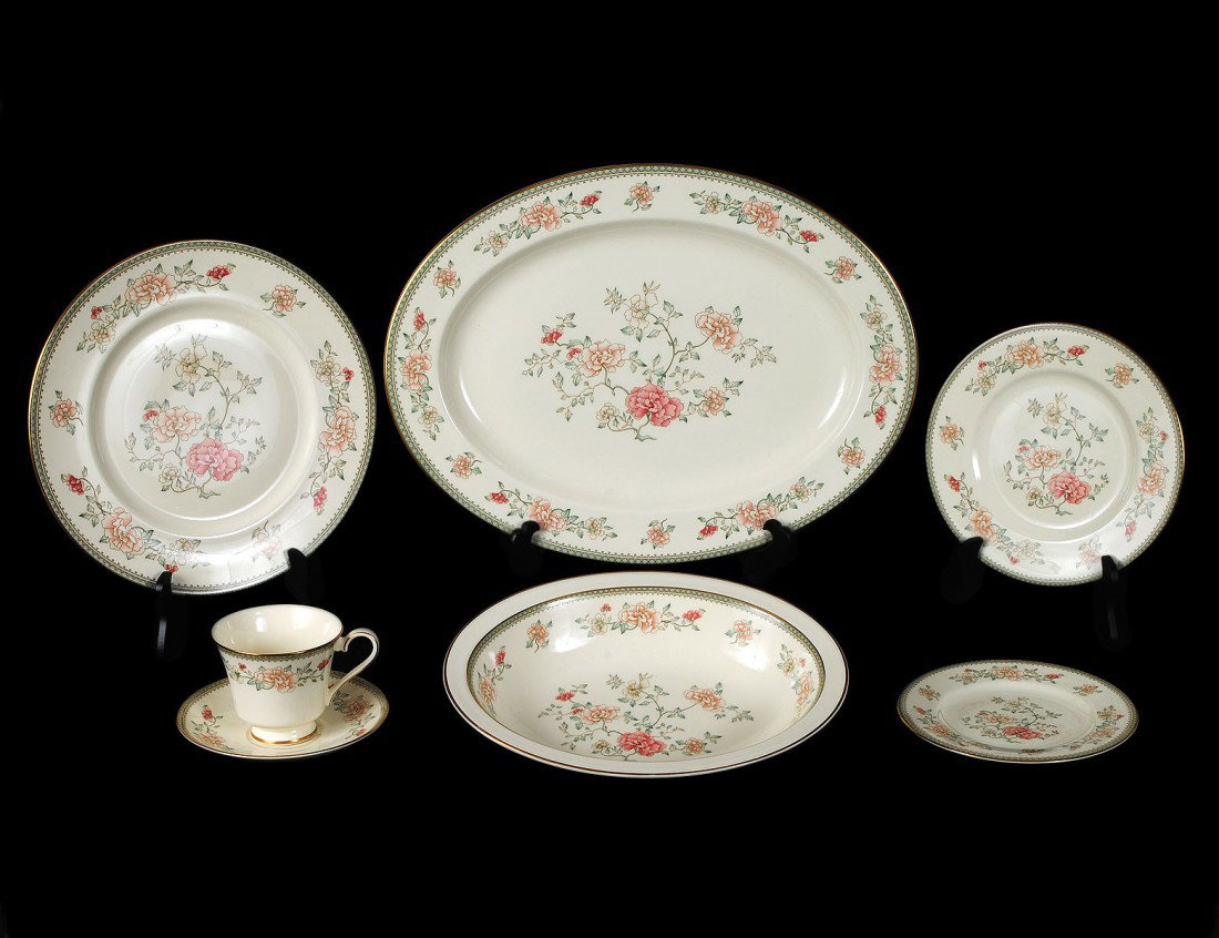 SIXTY-TWO PIECE MINTON PORCELAIN DINNER SERVICE: English. In the "Jasmine" pattern. Comprising: twelve dinner plates, twelve salad plates, twelve bread and butter plates, twelve cups and saucers, a platter and an open vegetable dish. (400/500)