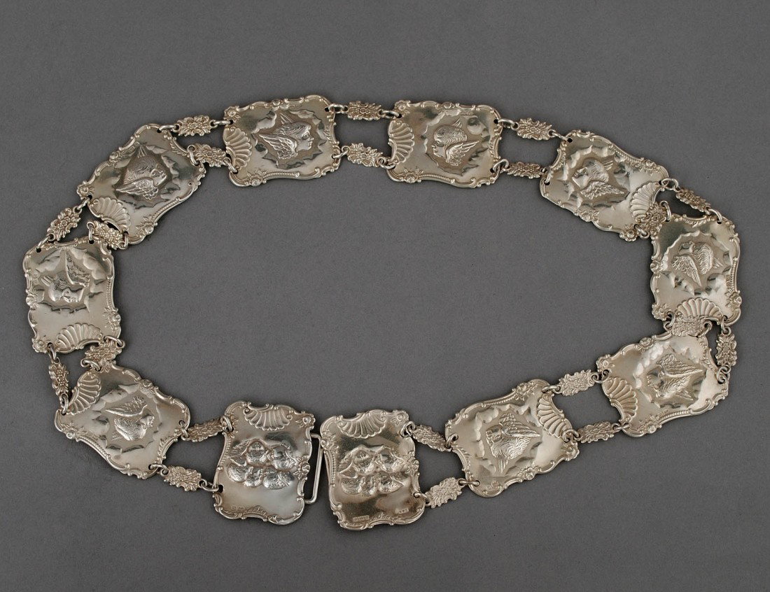 EDWARD VII STERLING SILVER BELT: English. Birmingham. 1902. Maker: L&S. Composed of plaques embossed with an angel head. Length 28 3/4". (4 oz) (600/800)