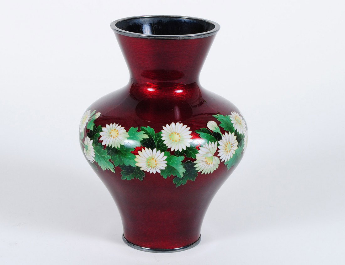 FINE CLOISONNE ENAMEL VASE ON SILVER: Japanese. 20th Century. By Ando Gubei. Decorated with a band of flowers on a red foil ground. Height 9”. (800/1200)
