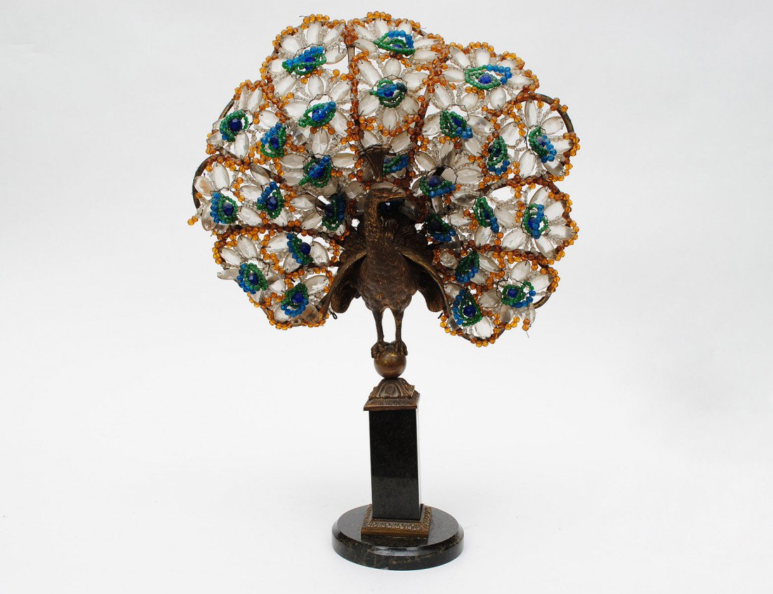 INTERESTING GILT BRONZE AND GLASS PEACOCK LAMP: 20th Century. The bird with open tail feathers standing on a sphere, raised on a marble pedestal base. Height 22 1/2". (300/400)