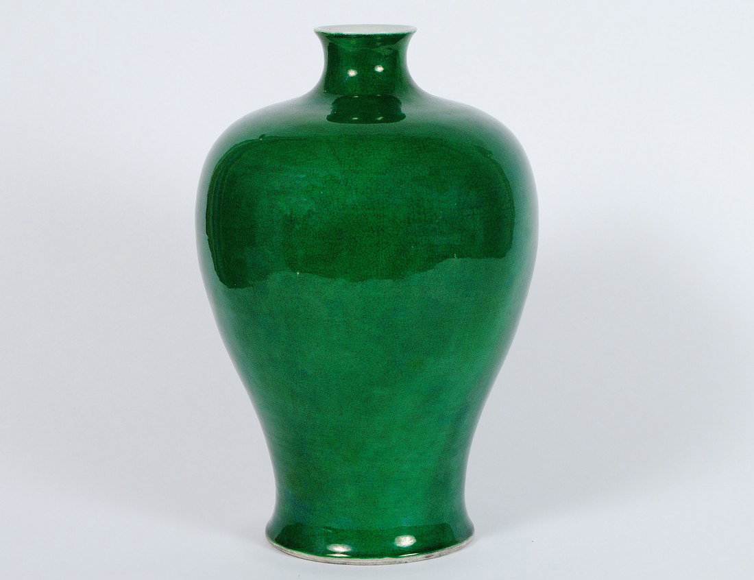GREEN CRACKLE GLAZED PORCELAIN VASE: Chinese. With six character Kangxi mark and double ring circles, but of a later period. Of mei-ping form. Height 14 ¼”. (700/900)