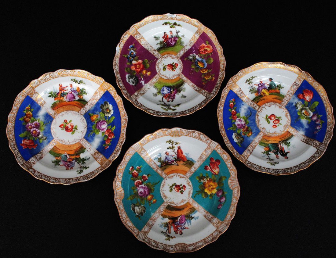SET OF FOUR MEISSEN PORCELAIN CAKE PLATES: German. 20th Century. Each with underglaze blue crossed swords. With double cancellation mark. Comprising: two blue, one raspberry and one turquoise. (Cond: chips) (60/80)