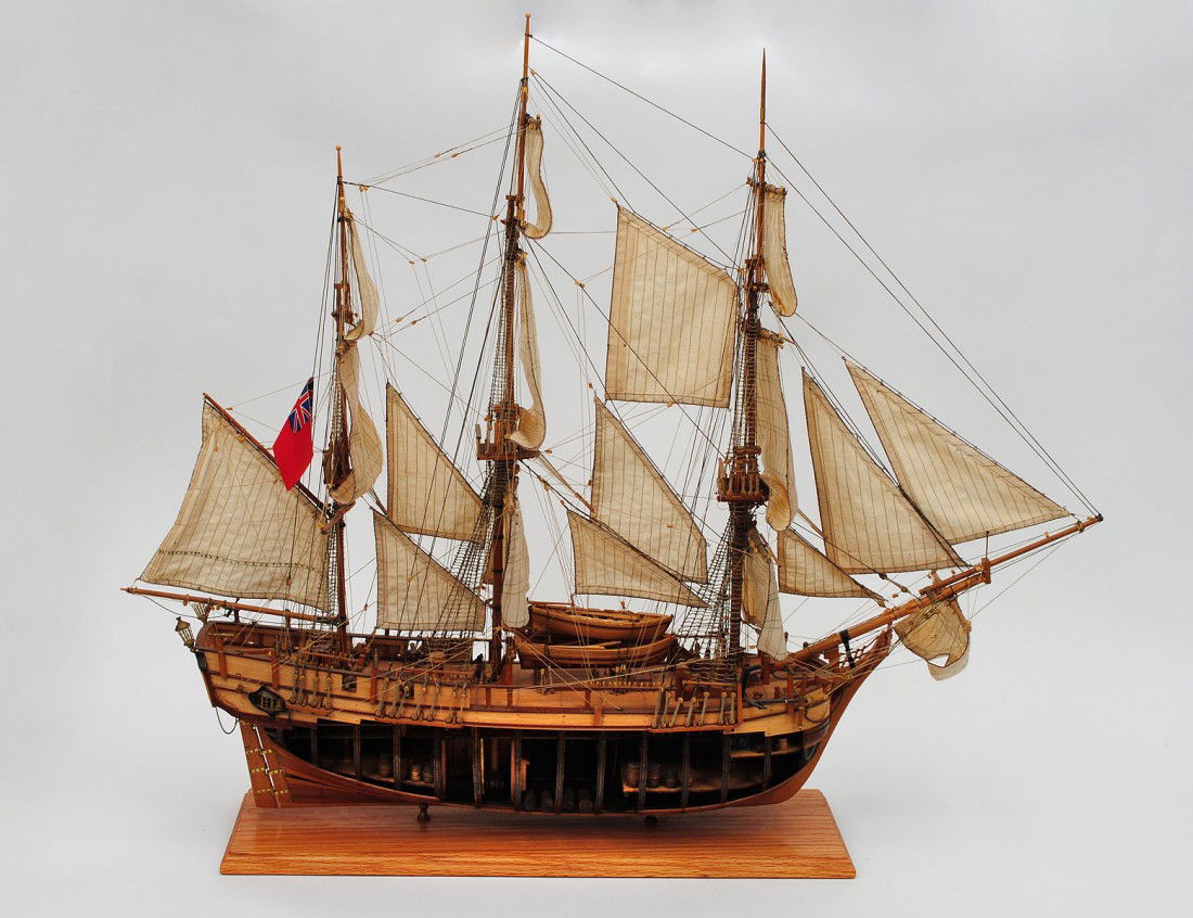 CUT-AWAY MODEL OF A THREE MASTED SCHOONER: With full sails, riggings, life boats, cannons and cargo. Height 31 3/4". Length 38 1/2". (600/800)