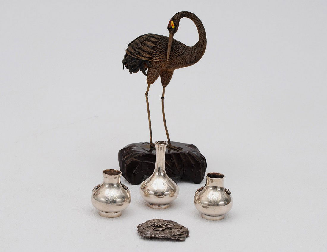 GROUP OF FIVE ASSORTED SILVER ARTICLES: Comprising: a Chinese silver gilt and enamel crane mounted on a wood base, height 7 ¾”; a Chinese belt buckle chased with a dragon; and three Japanese miniature silver vases, heights 1 ¾” to 2 �