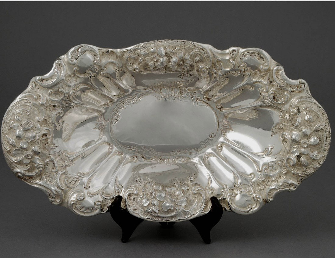 STERLING SILVER BOWL: American. 20th Century. Maker: Mauser. Of oval shape embossed with flower heads. Length 14". (14 oz) (250/350)