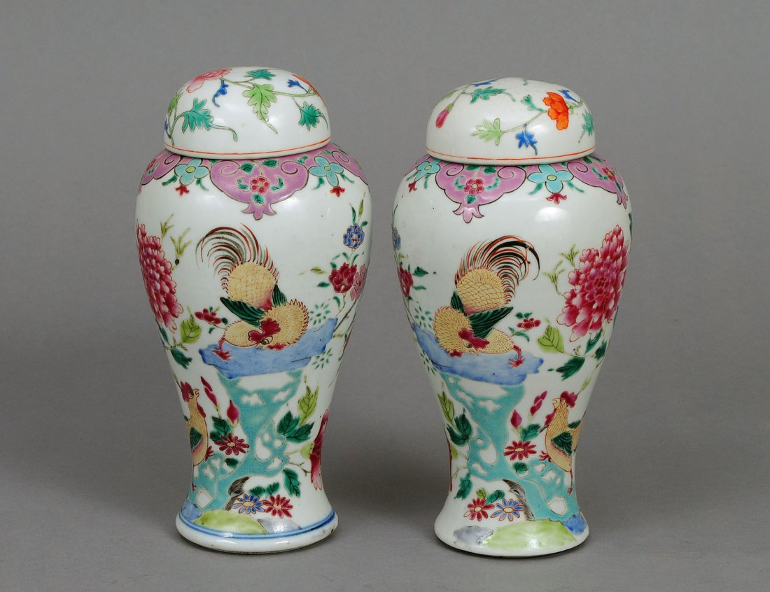 PAIR OF FAMILLE ROSE PORCELAIN VASES AND COVERS: Chinese. Qing Dynasty. Each of mei ping shape, enameled with roosters, chrysanthemums, blossoms and insects. Height 9". Note: Although matched, one with double ring blue and white circle at the base. 