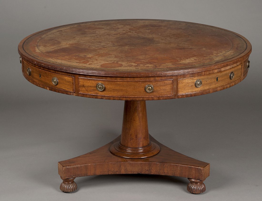 WILLIAM IV MAHOGANY DRUM TABLE: English. 19th Century. With tooled leather inset top above four real and four false drawers, the columnar standard on a tripod base with reeded half bun feet. Height 30 1/4". Diameter 47 1/8". (2000/3