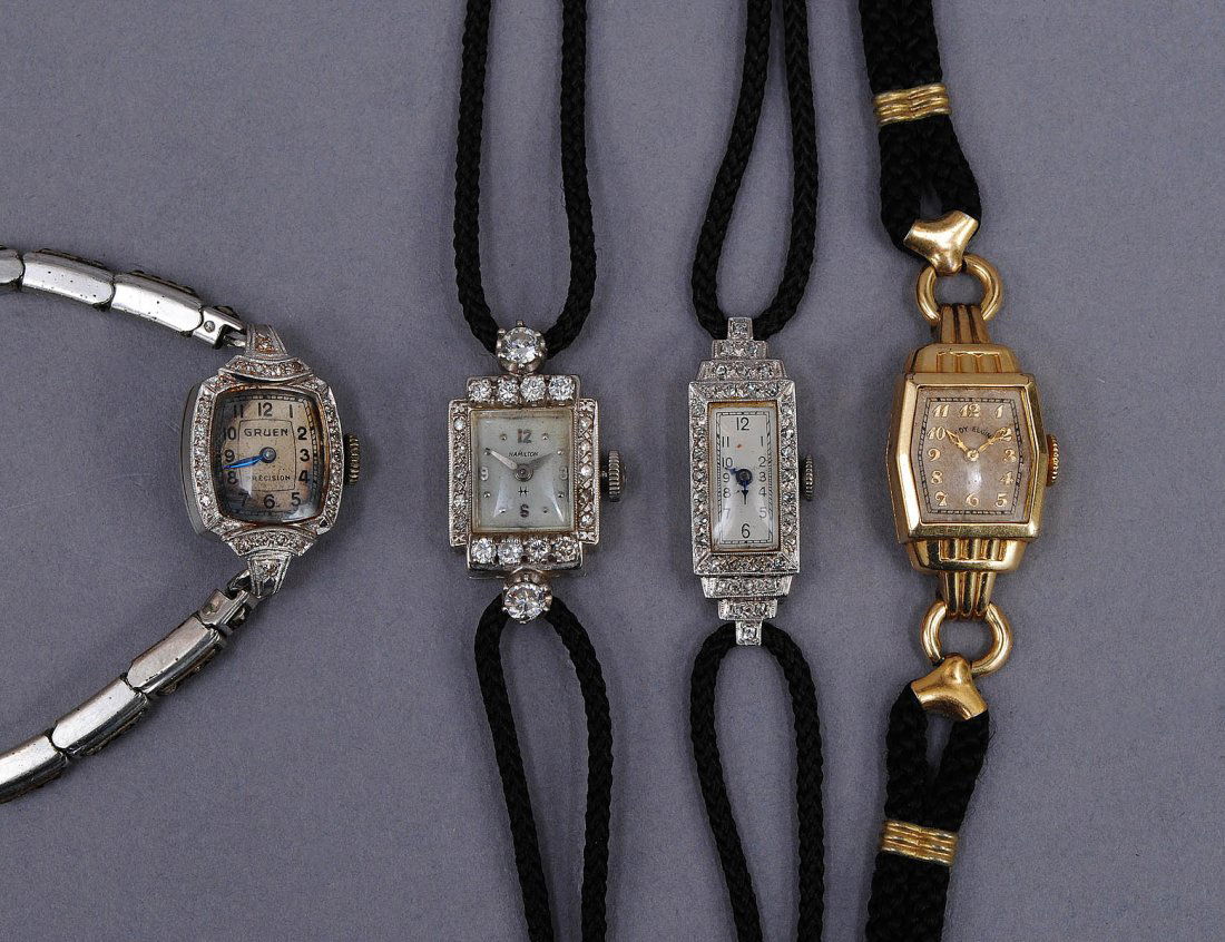 GROUP OF FOUR LADIES WRIST WATCHES: Comprising: fourteen karat white gold and diamond Hamilton, fourteen karat white gold and diamond Gruen, platinum and diamond Swiss made and a fourteen karat gold filled by Lady Elgin. (100/200)
