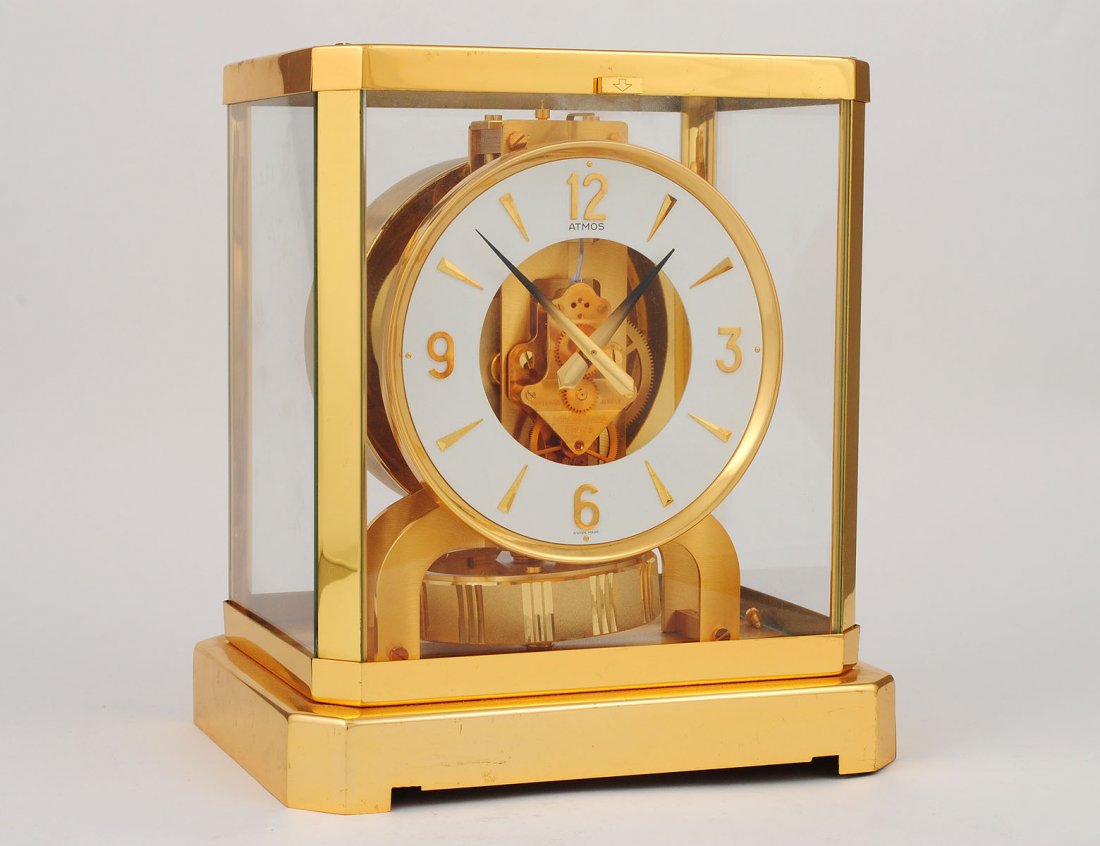 ATMOS MANTEL CLOCK: Swiss. By Jaeger Le Coultre. In a brass and glass case. Height 9 1/8". (400/500)