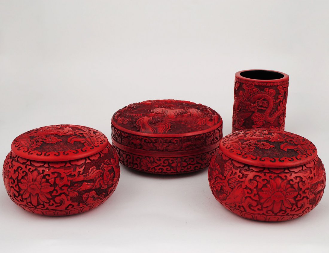 GROUP OF FOUR CINNABAR TABLE ARTICLES: Chinese. 20th Century. Comprising: brush pot, height 4 1/4" and three boxes and covers, diameters 5 1/2" to 6 3/4". (300/400)
