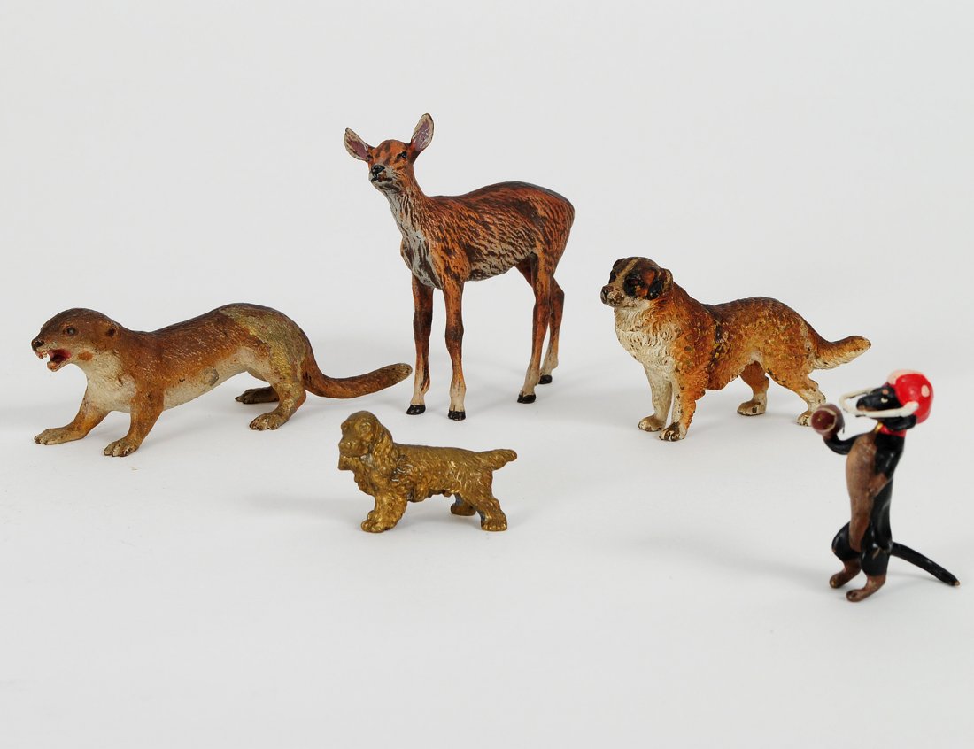 GROUP OF THREE VIENNA COLD PAINTED BRONZE ANIMALS: Austrian. Comprising: weasel, deer and a dog. Together with a gilt metal dog and a painted metal dog. (5 pcs) (100/150)