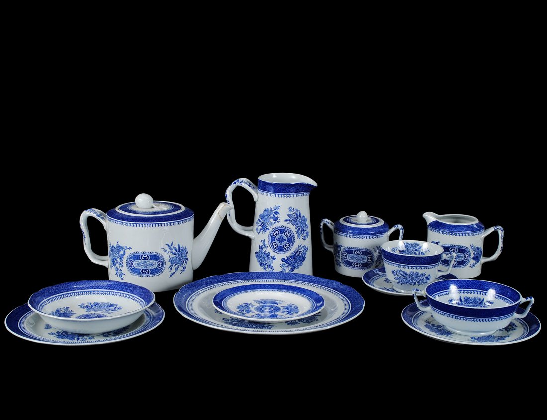 SIXTY-THREE PIECE SPODE STONE PART DINNER SERVICE: English. In the "Fitzhugh Blue" pattern. Comprising: seven dinner plates, ten salad plates, five soup bowls, seven bread and butter plates, seven cream soups and stands, eight cups and saucers, tea po