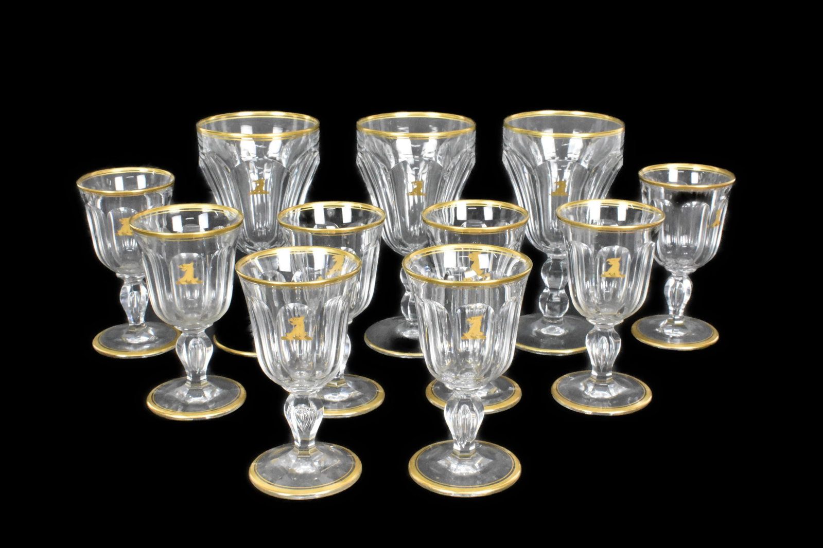 Group of Eleven French Hollow Tear Drop Stem Wine Glasses, 20th Century, with faceted bowls each: Group of Eleven French Hollow Tear Drop Stem Wine Glasses, 20th Century, with faceted bowls each having a gilded Eagle Head Crest and gilded rims and foot, red-6 5/8" h. white-4 7/8", good condition, 