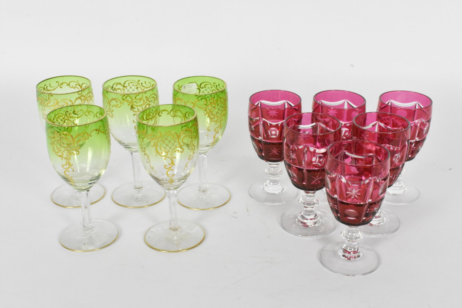 Group of Twelve Cut to Clear Color Liquor Glasses, Six Cranberry and Five Green Tinted with Gilded: Group of Twelve Cut to Clear Color Liquor Glasses, Six Cranberry and Five Green Tinted with Gilded strapwork decoration, 5 1/4" h., 4 3/4" h., all in excellent condition, no scratches, no blemishes.