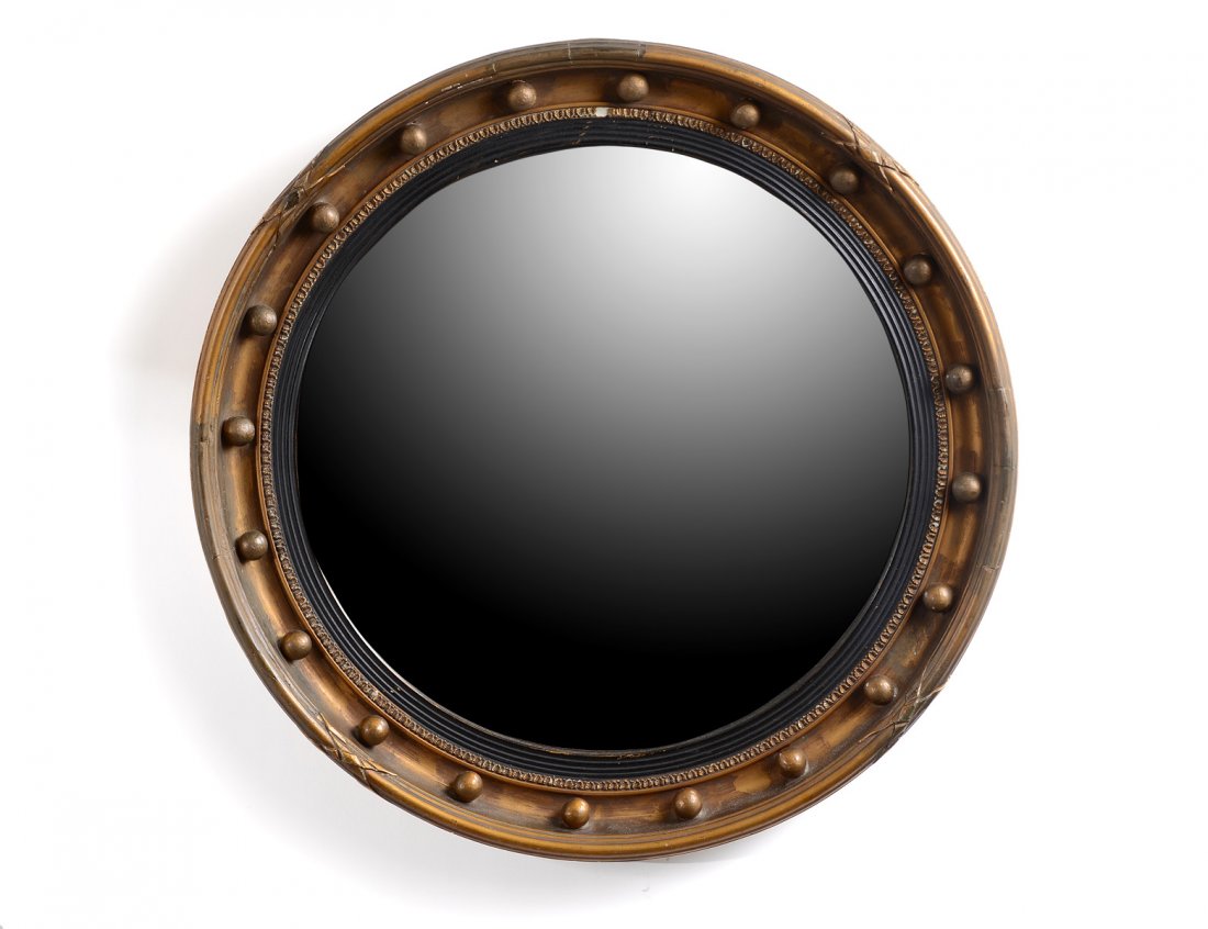 GEORGIAN STYLE GILT CONVEX MIRROR: The circular mirror plate enclosed by a reeded ebonized border, set in a molded frame with sprules. Diameter 21". (300/400)