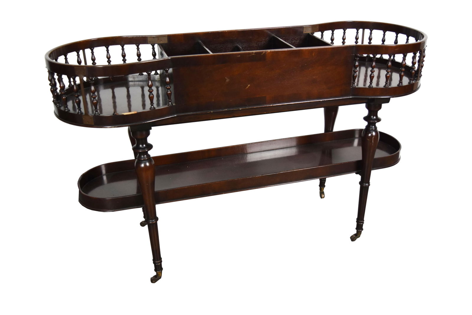 Contemporary Mahogany Serving Trolley with turned spindles and having a stretcher shelf, on casters,: Contemporary Mahogany Serving Trolley with turned spindles and having a stretcher shelf, on casters, 27" h. 44" w. 12" d., Note: missing two spindles and having nicks from wear and use.