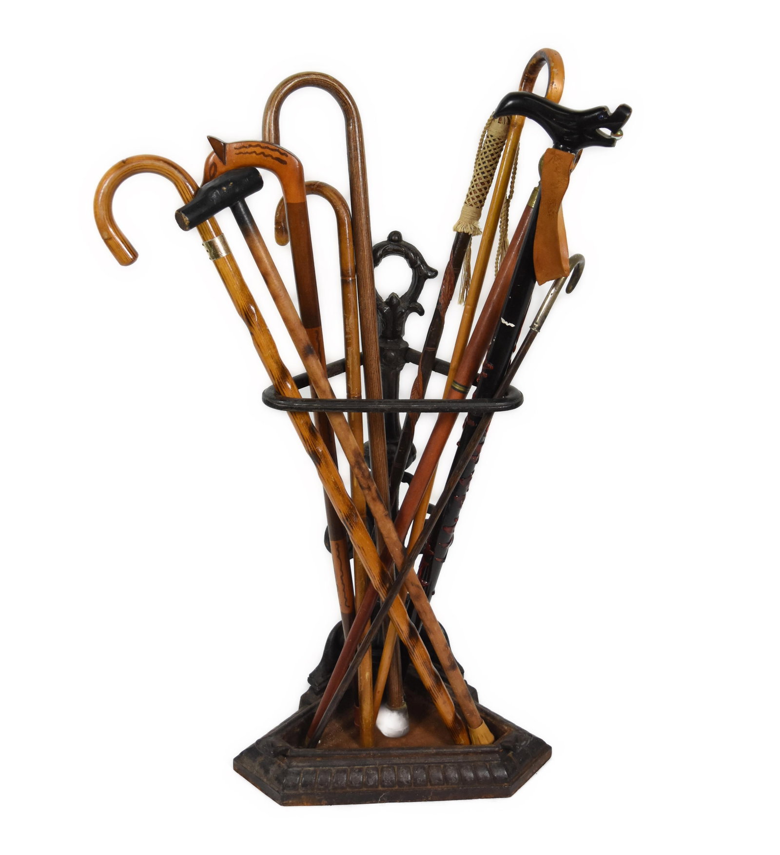 Group of Ten Assorted Wood Carved Walking Canes/Sticks in an antique cast iron stand, 28" h. 16" w. (1 of 3)