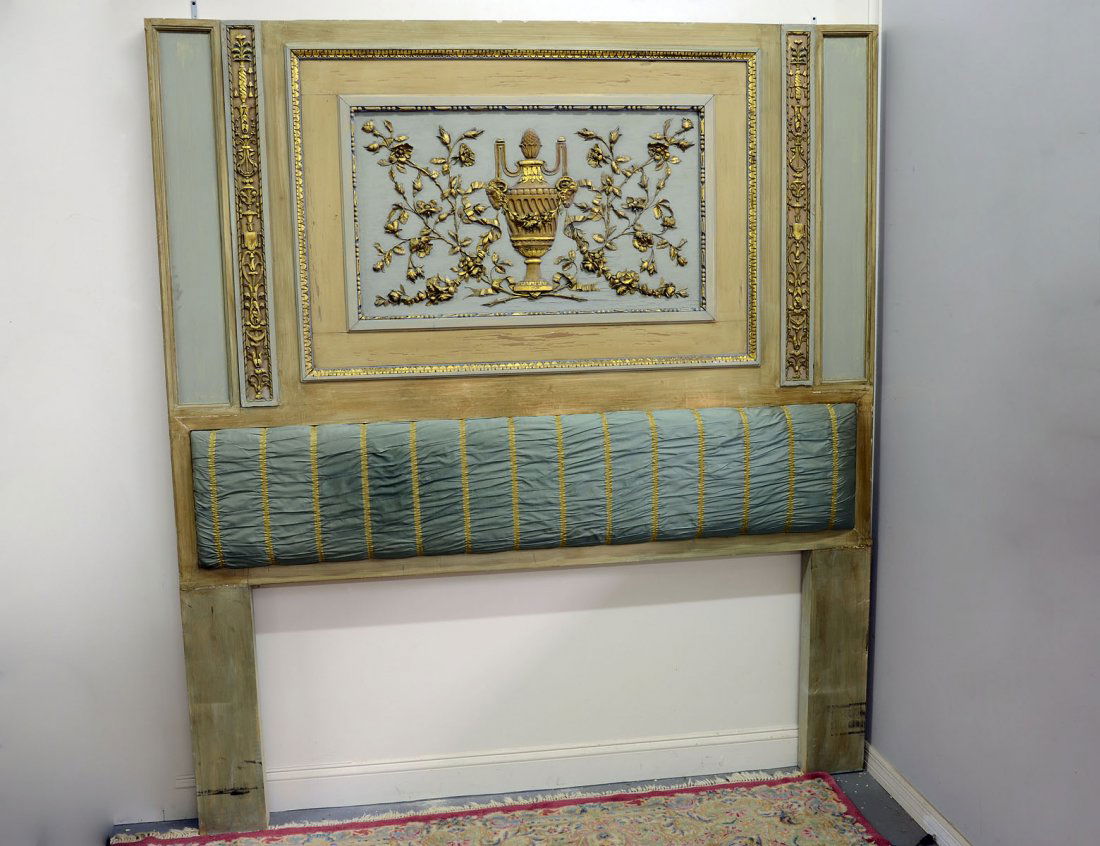 LOUIS XVI STYLE CARVED AND PAINTED HEADBOARD: The rectangular panel centered by an urn surrounded by flowering vines enclosed by gilt borders. Height 87 3/4". Width 78 1/4". (1000/1500)