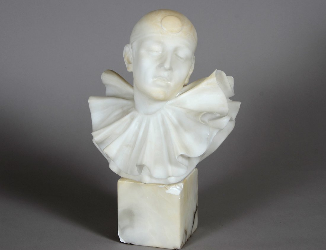 CARVED ALABASTER BUST OF A HARLEQUIN: European. Early 20th Century. Supported by a marble base. Height 13 3/4". (Cond: minute chips to edges, based with losses) (400/500)