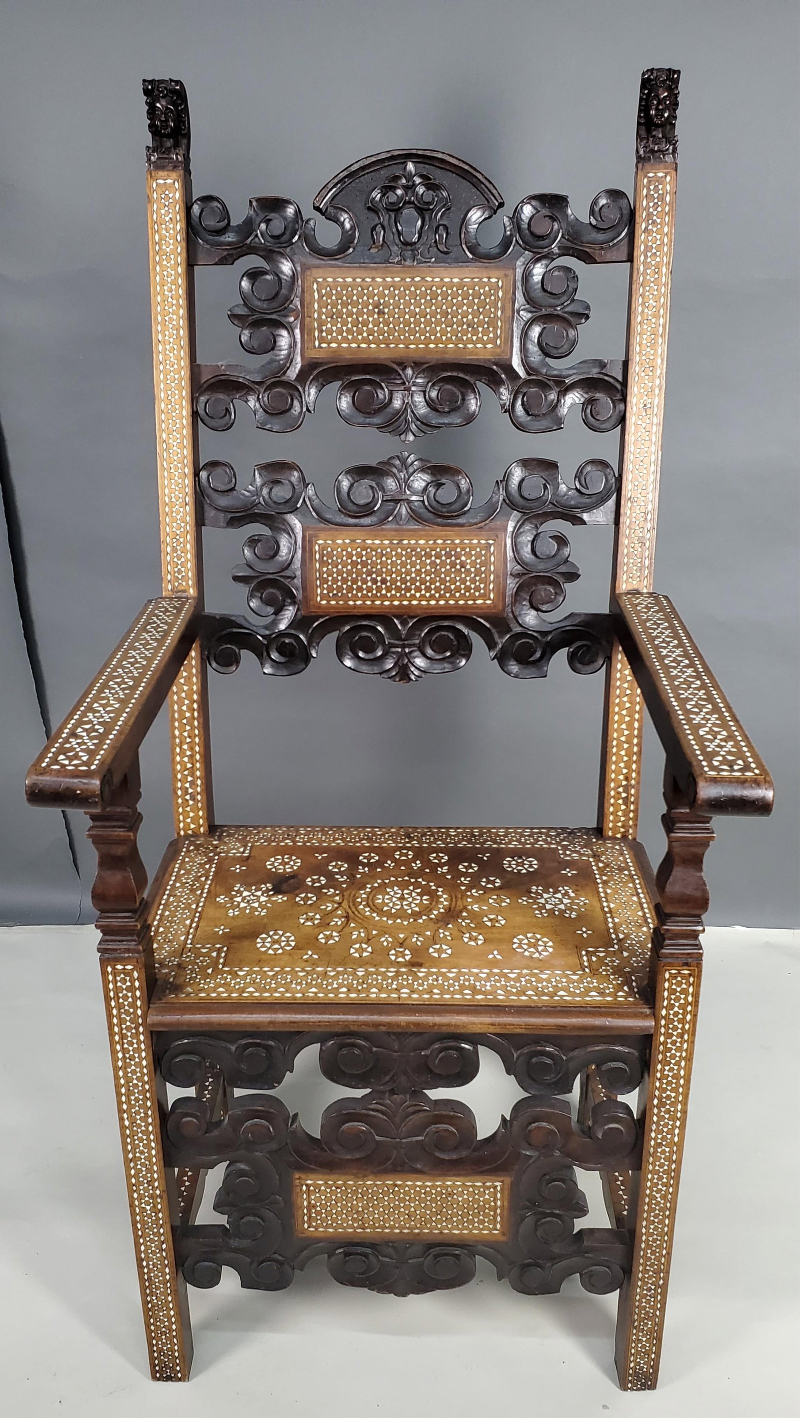 Antique Moorish Inlaid Armchair, with carved heads and having intricate bone inlay, 53 3/4" h.23: Antique Moorish Inlaid Armchair, with carved heads and having intricate bone inlay, 53 3/4" h.23 1/2" w. 22" d. Seat Height-20 1/2"