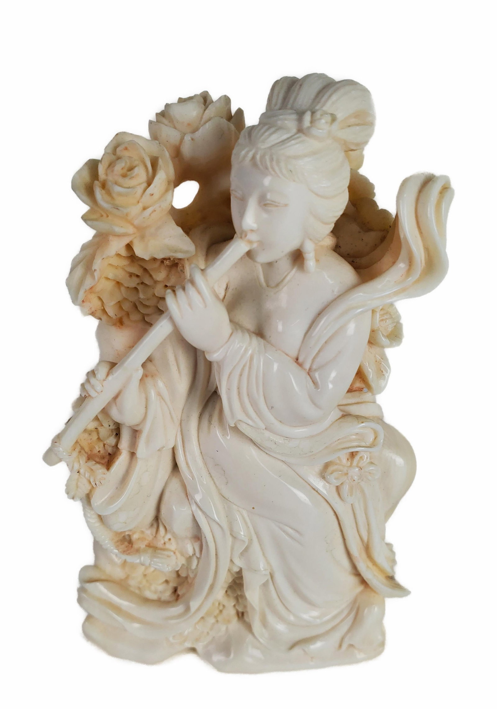 Chinese Carved Figure of a Female Musician with Flower Blooms, 4" h. 2 1/2" w. 1 1/4" d. Note: This: Chinese Carved Figure of a Female Musician with Flower Blooms, 4" h. 2 1/2" w. 1 1/4" d. Note: This lot can only be picked up at the gallery by the buyer or an agent assigned by the buyer. NO INTERNAT