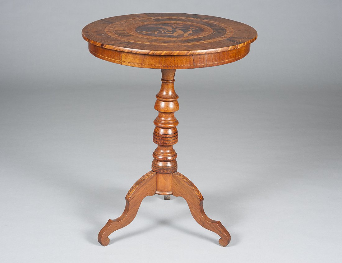 INLAID TILT-TOP TRIPOD TABLE: Italian. The circular top inlaid with birds and chevron borders above the turned standard, raised on shaped legs. Height 29 1/2". Diameter 23 1/2". (300/400)