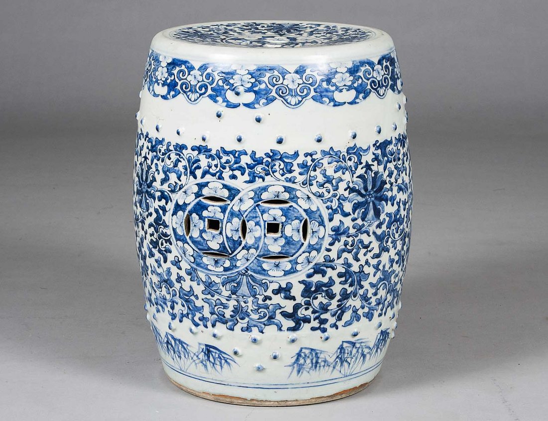 BLUE AND WHITE PORCELAIN GARDEN SEAT: Chinese. 20th Century. Of barrel form pierced with cash medallions and molded with raised knobs. Height 18 ½”. (300/400)