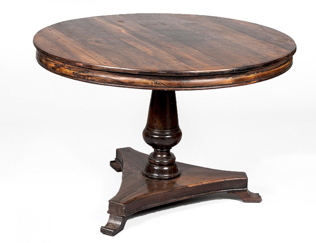REGENCY ROSEWOOD BREAKFAST TABLE: English. 19th Century. The circular top tilting above the vase form standard, raised on a tripod base with scroll feet. Height 30 ½”. Diameter 46 ½”. (1000/1500)