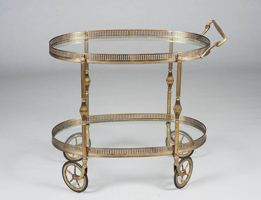 BRASS SERVING CART: Composed of two glass lined tiers each enclosed by a pierced gallery. Height 28”. Length 29 ¾”. (100/150)