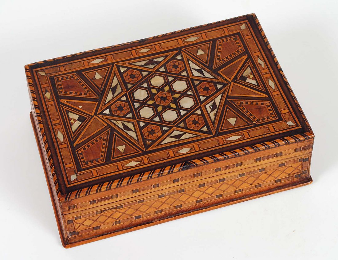 MOTHER OF PEARL INLAID WOOD BOX: Middle Eastern. Of rectangular shape with hinged cover. Length 8 1/2". (50/75)