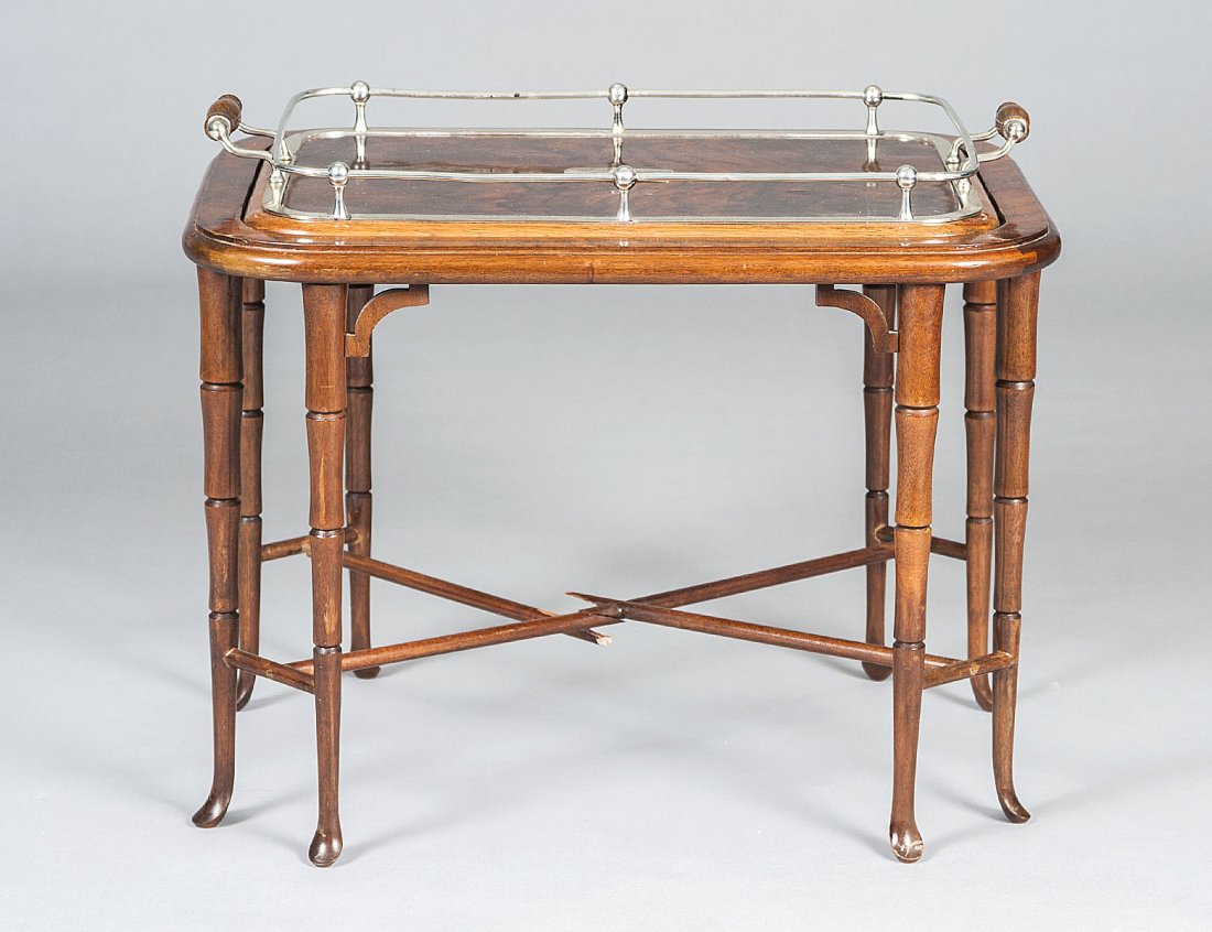 REGENCY STYLE SIMULATED BURL AND FAUX BAMBOO TRAY/: The rectangular frame supporting a removable tray with silver plated gallery, raised on faux bamboo legs. Height 19 ¼”. Length 22 ¾”. Depth 17”. (150/200)