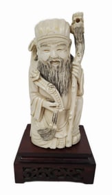 Chinese Carved Figure of a Jurojin with Sceptre and Staff, 5 1/8" h. 2 3/8" w., on a wood stand