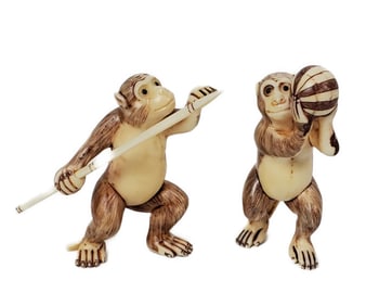 Two Japanese Carved Bone Monkey Netsukes, One with a spear and one holding a ball, one marked, 2