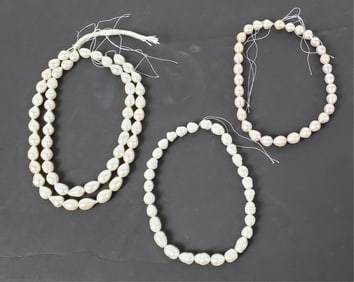 Three Strands of Natural Pearls, longest-32", will need to be strung properly.