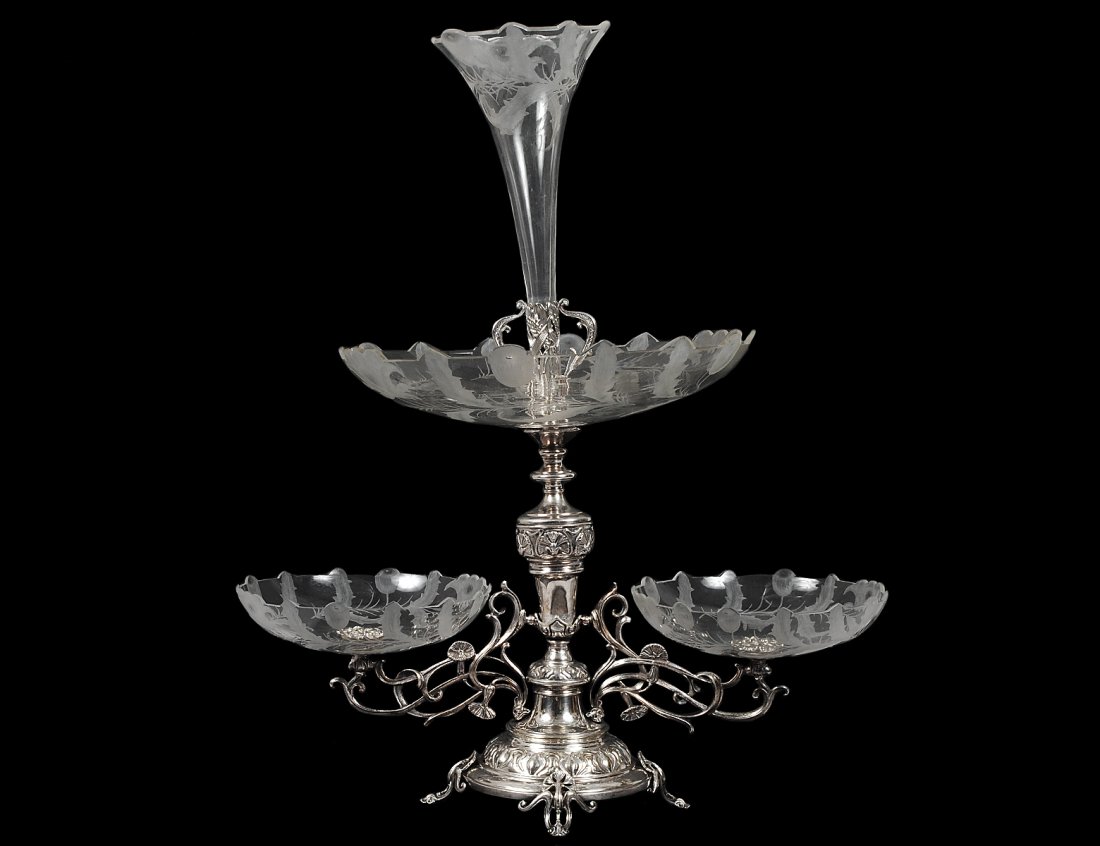 VICTORIAN SILVER PLATED AND ETCHED GLASS EPERGNE: Probably English. Late 19th Century. The central standard supporting a pair and a larger center glass dish and surmounted by a glass vase. Height 25”. (500/700)